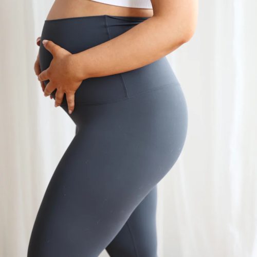 SeamlessLuxeLeggingsSlate_2 Woman wearing Seamless Luxe Maternity Leggings in slate, side view.