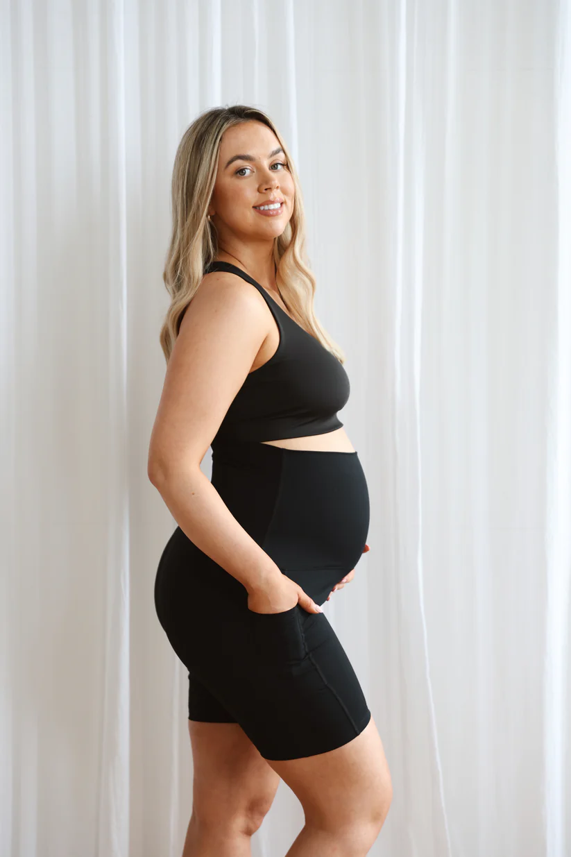 Tezza-3984 Model wearing black seamless maternity shorts with high waistband.